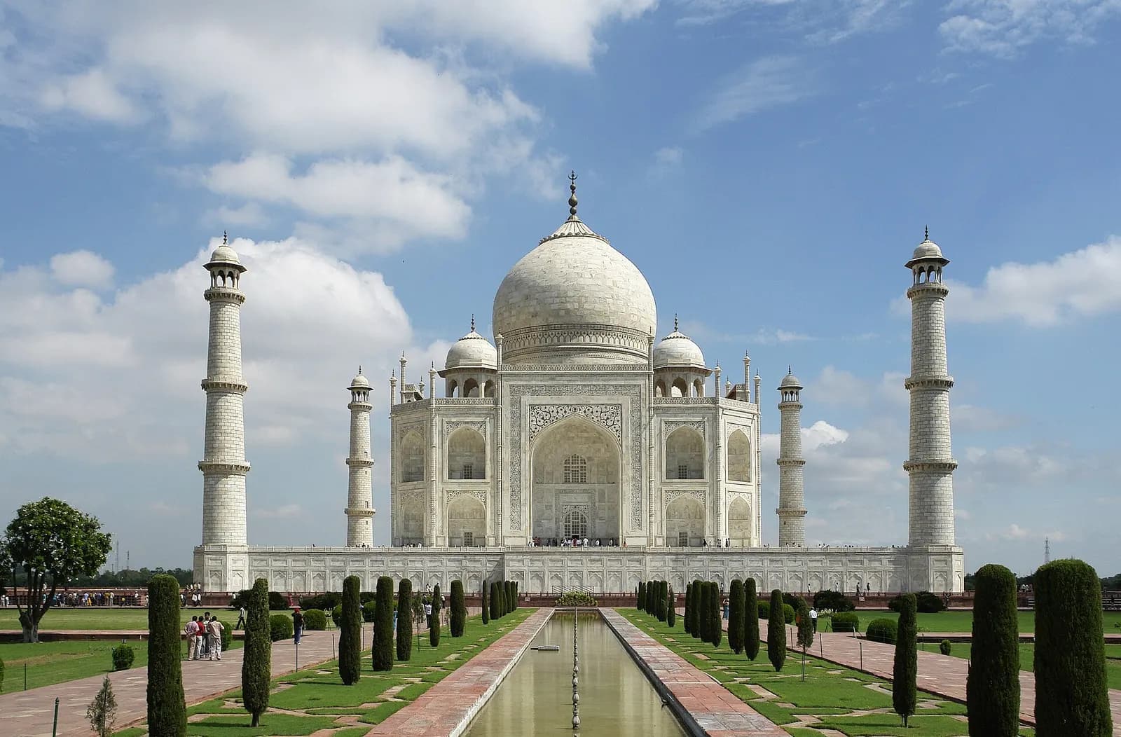 The white marble Taj Mahal in Agra seen across its reflecting watercourse