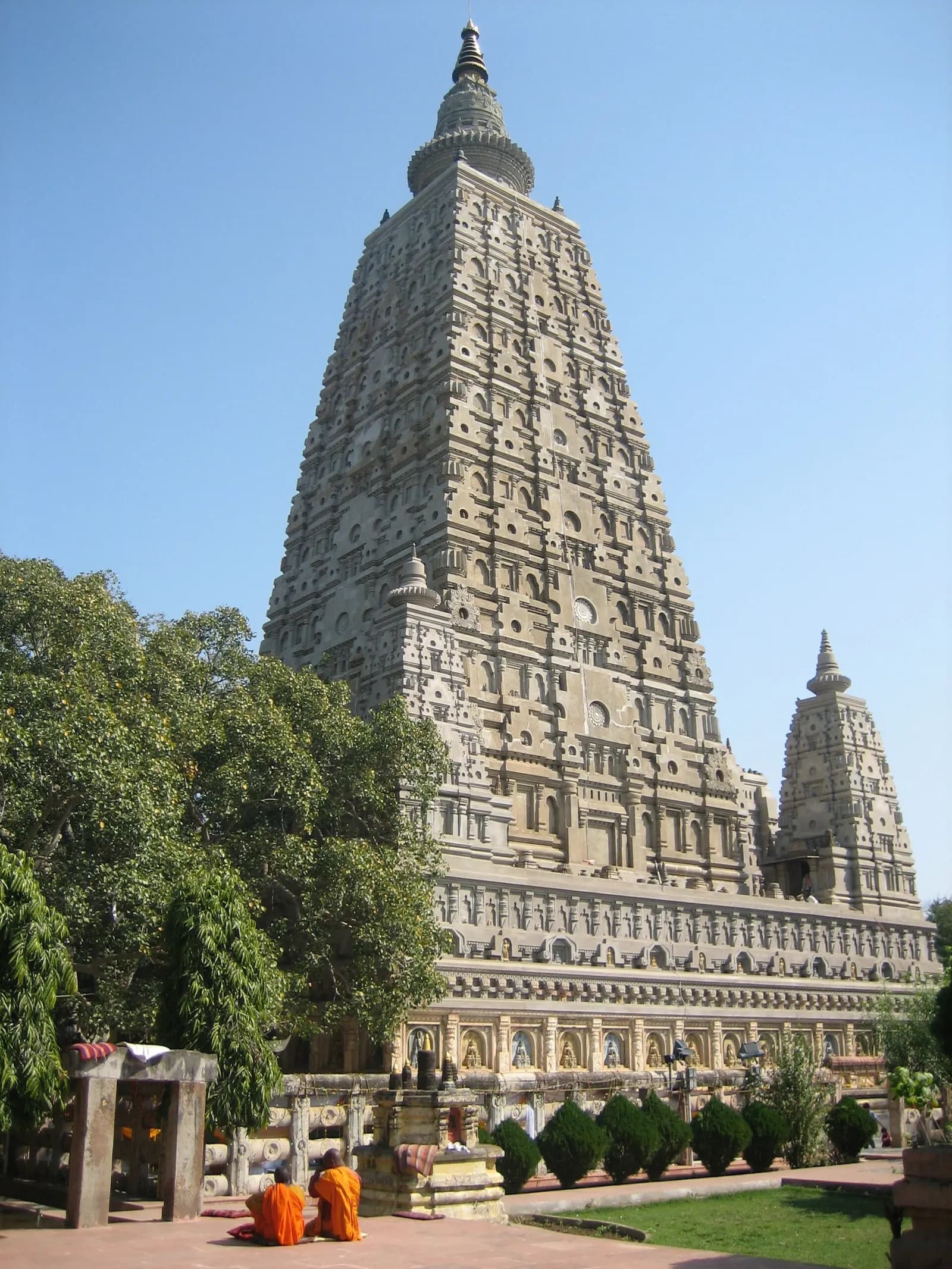 The tall brick spire of the Mahabodhi Temple at Bodh Gaya rising above pilgrims and prayer flags